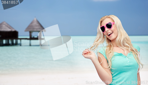 Image of happy young blonde woman or teenager in sunglasses