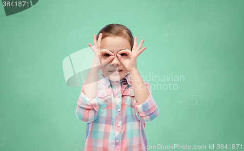 Image of happy little girl making faces and having fun