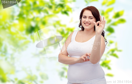 Image of plus size woman in underwear showing ok hand sign