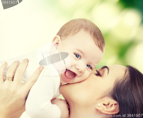 Image of laughing baby playing with mother