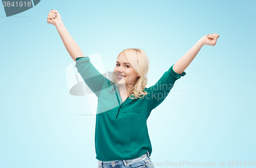 Image of smiling young woman in shirt and jeans