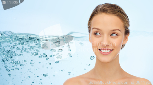 Image of smiling young woman face and shoulders