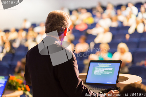 Image of Speaker at Business Conference and Presentation.