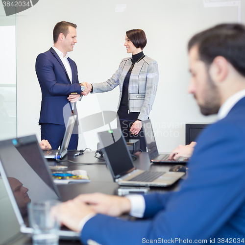 Image of Business people shaking hands.