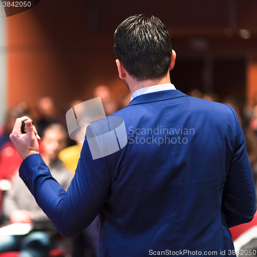 Image of Public speaker giving talk at Business Event.