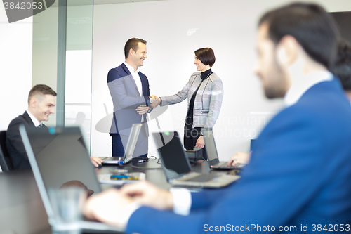 Image of Business people shaking hands.