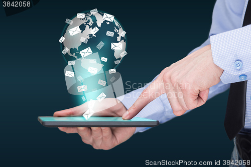 Image of Businessman holding a tablet pc with mobile applications icons on virtual screen . Internet and business concept. message. mail.