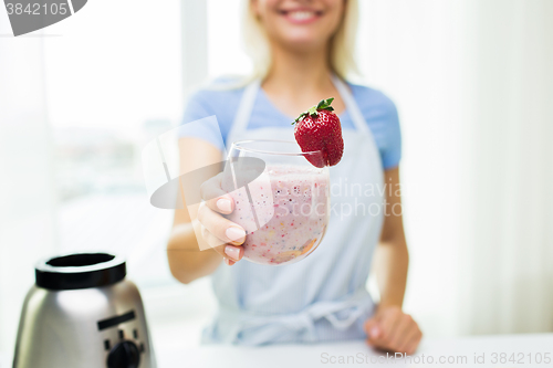 Image of close up of woman holding glass with fruit shake