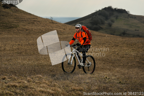 Image of Man cyclist with backpack riding the bicycle