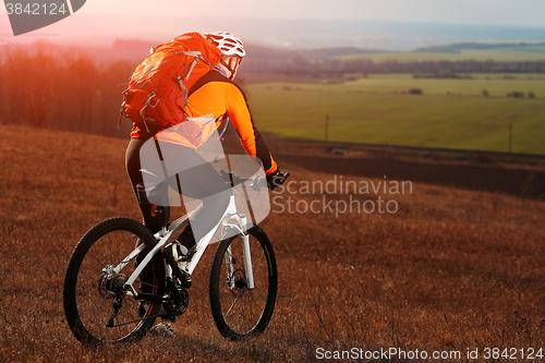 Image of Man cyclist with backpack riding the bicycle