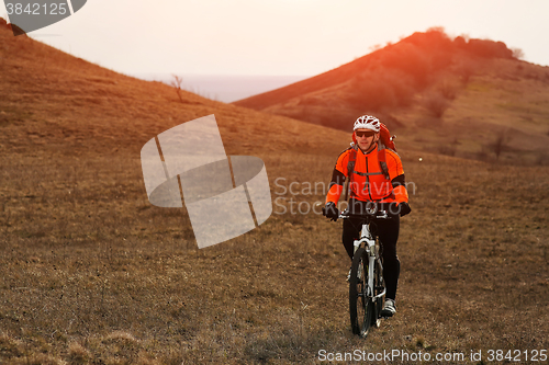 Image of Man cyclist with backpack riding the bicycle