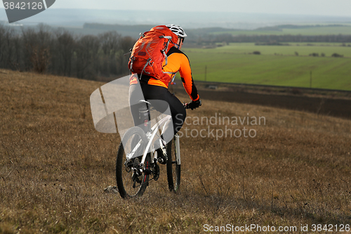 Image of Man cyclist with backpack riding the bicycle