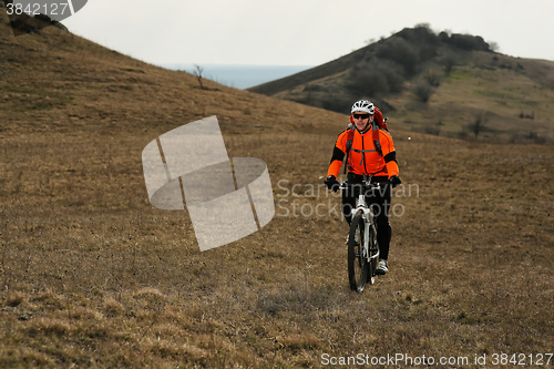 Image of Man cyclist with backpack riding the bicycle