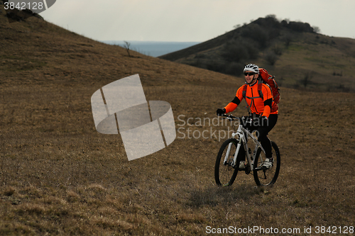 Image of Man cyclist with backpack riding the bicycle