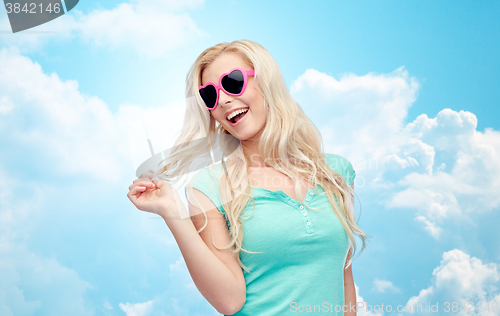 Image of happy young blonde woman or teenager in sunglasses