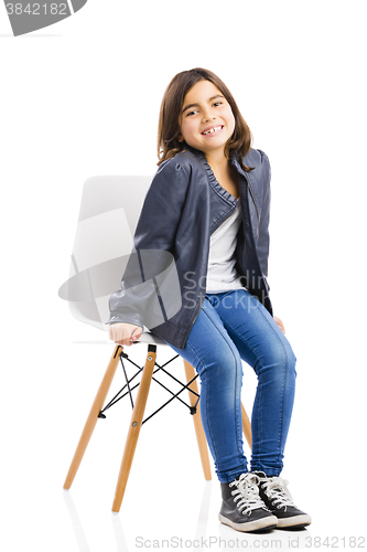 Image of Beautiful young girl sitting on a chair