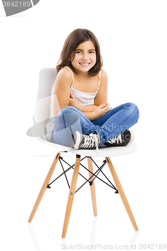 Image of Beautiful young girl sitting on a chair