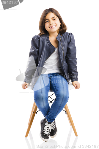 Image of Beautiful young girl sitting on a chair