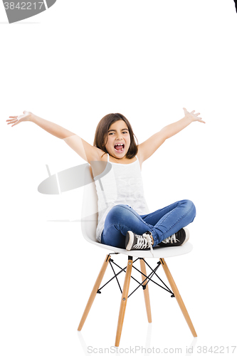 Image of Beautiful young girl sitting on a chair
