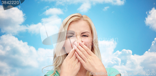 Image of young woman or teenage girl closing her nose