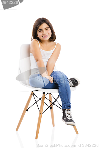 Image of Beautiful young girl sitting on a chair