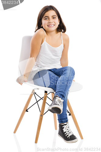 Image of Beautiful young girl sitting on a chair