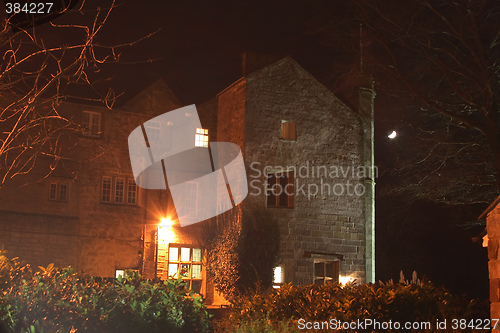 Image of stately home lit at night