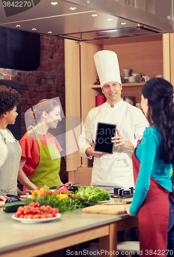 Image of happy women with chef and tablet pc in kitchen