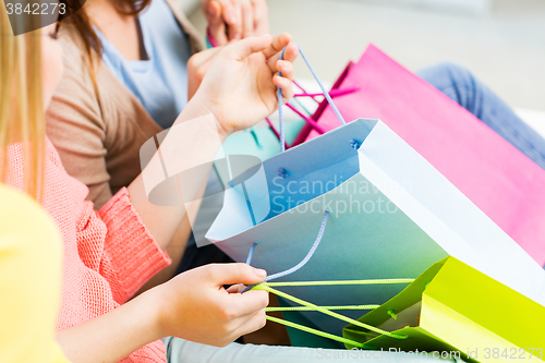 Image of close up of happy teenage girls with shopping bags