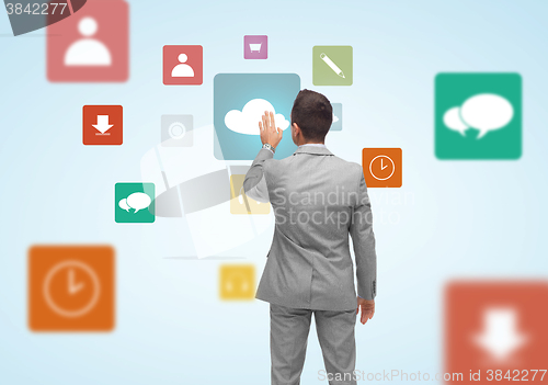 Image of businessman with virtual projection of media icons