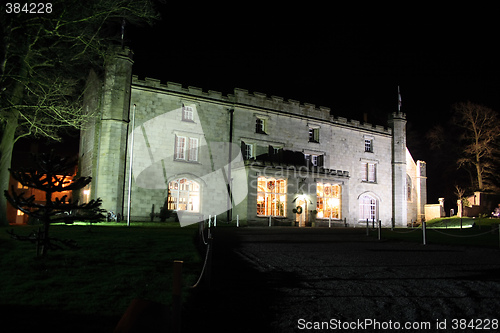 Image of stately home lit at night