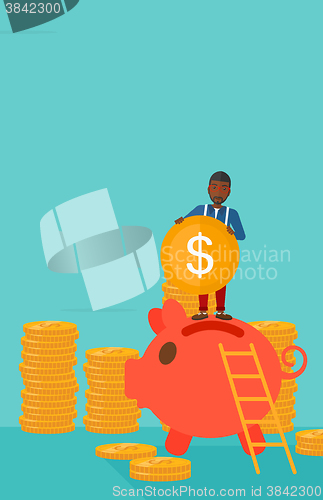 Image of Man putting coin in piggy bank.