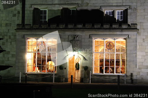 Image of stately home windows and door lit at night