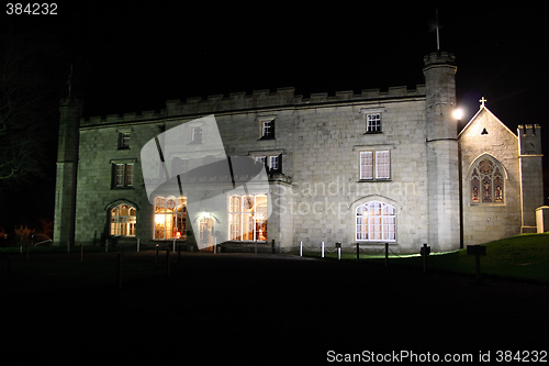 Image of stately home lit at night