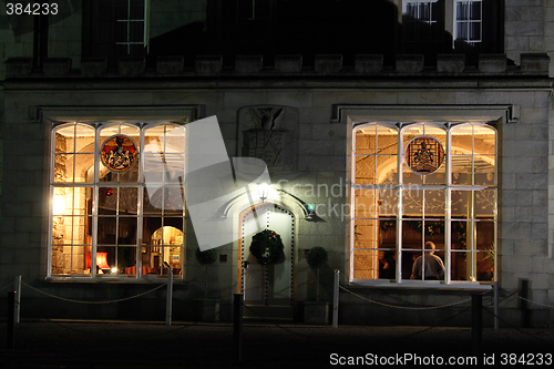 Image of stately home windows and door lit at night