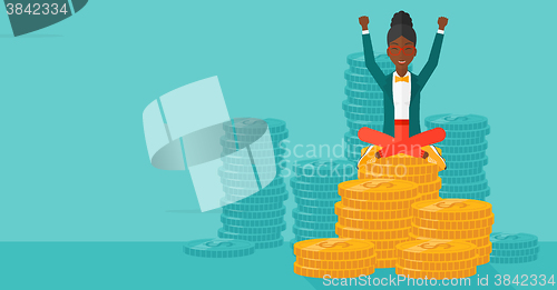Image of  Happy business woman sitting on coins.