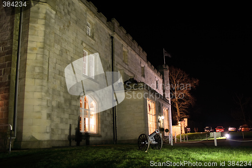 Image of stately home lit at night