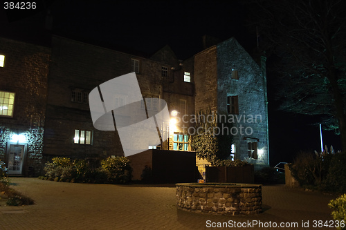 Image of stately home lit at night