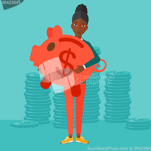 Image of Woman carrying piggy bank.