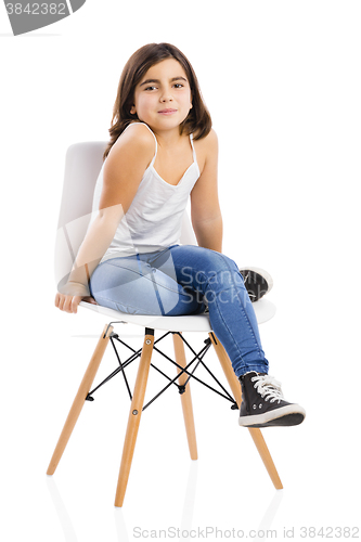 Image of Beautiful young girl sitting on a chair