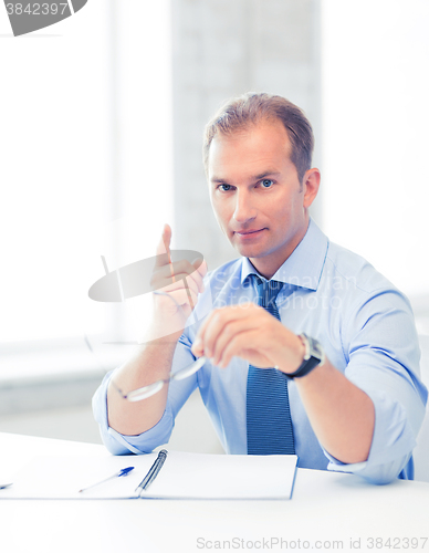 Image of businessman showing warning gesture