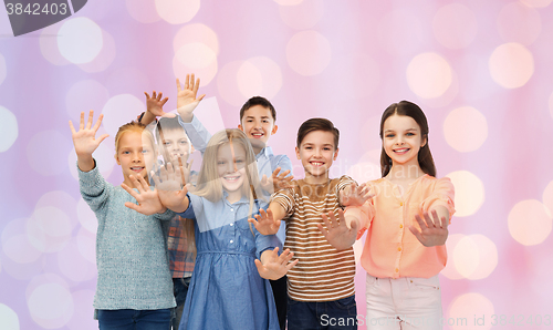 Image of happy children waving hands