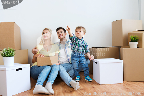 Image of happy family with boxes moving to new home