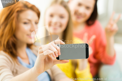 Image of close up of friends taking selfie with smartphone