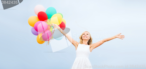 Image of woman with colorful balloons outside