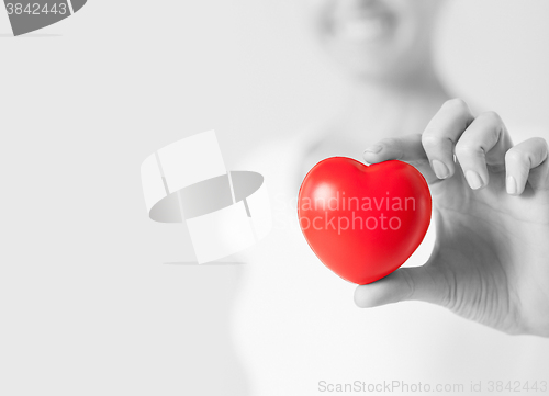 Image of happy woman with small red heart