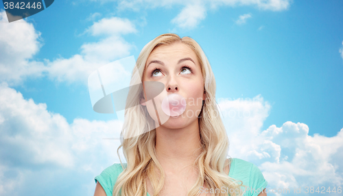 Image of happy young woman or teenage girl chewing gum