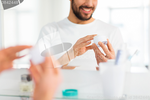 Image of close up of happy young man with cream at bathroom