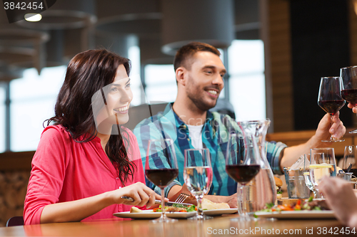 Image of friends clinking glasses of wine at restaurant