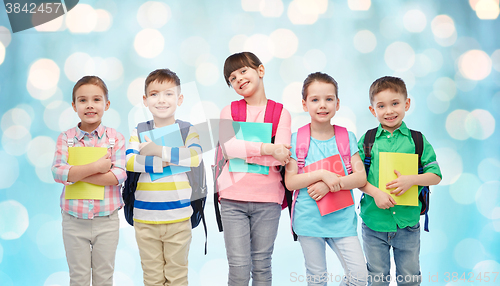 Image of happy children with school bags and notebooks